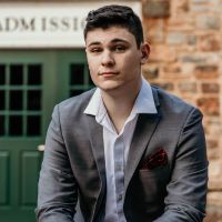 Young man in a suit, representing the launch of Scroll News